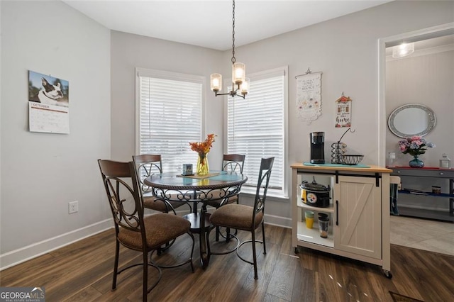 dining space featuring dark hardwood / wood-style floors and a notable chandelier