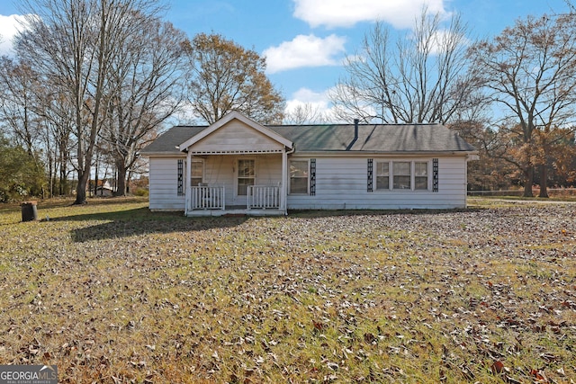 ranch-style home with a porch and a front yard