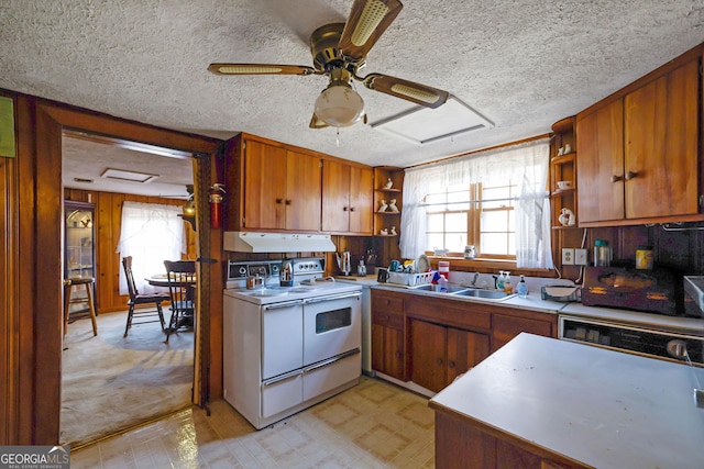 kitchen with white electric range oven, sink, and a textured ceiling