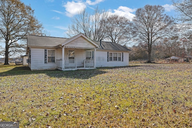 single story home with covered porch and a front yard