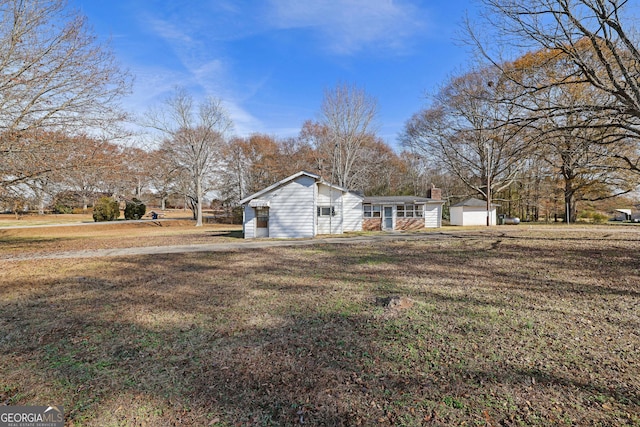 view of side of home featuring a yard and a garage