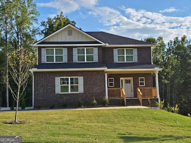 view of front of property with a front lawn and brick siding