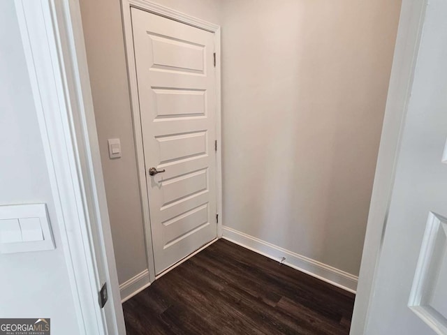 entryway featuring dark wood-style floors and baseboards