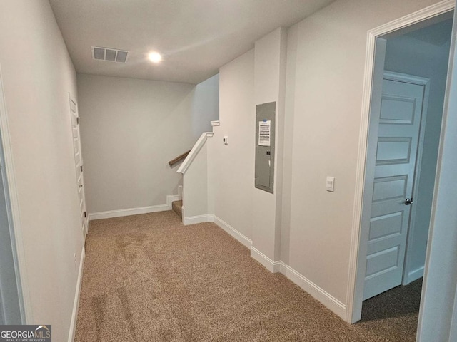 interior space featuring carpet floors, baseboards, stairs, and visible vents