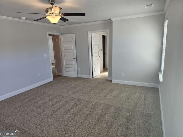 unfurnished bedroom with ornamental molding, carpet flooring, and baseboards