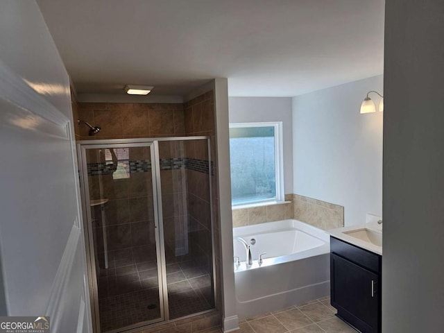 full bathroom with a stall shower, tile patterned flooring, a bath, and vanity