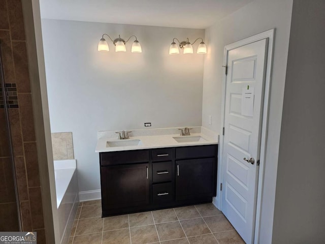 bathroom featuring double vanity, a sink, a bath, and tile patterned floors