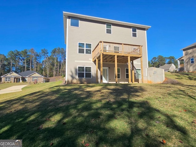 rear view of house with a yard and a wooden deck