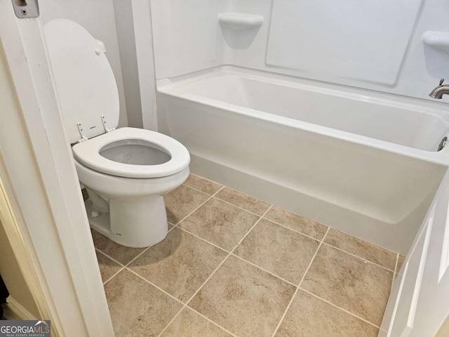 bathroom with toilet and tile patterned floors