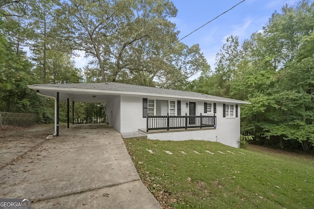 ranch-style house with a front yard and a carport