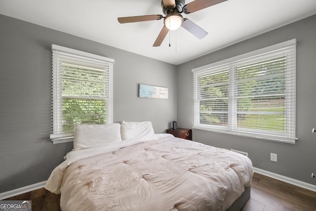 bedroom featuring ceiling fan and dark wood-type flooring