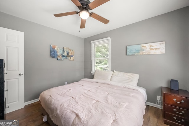 bedroom with ceiling fan and dark wood-type flooring