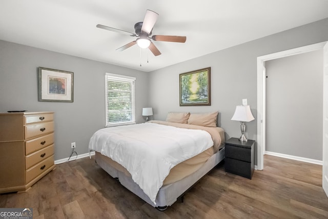 bedroom with dark hardwood / wood-style floors and ceiling fan