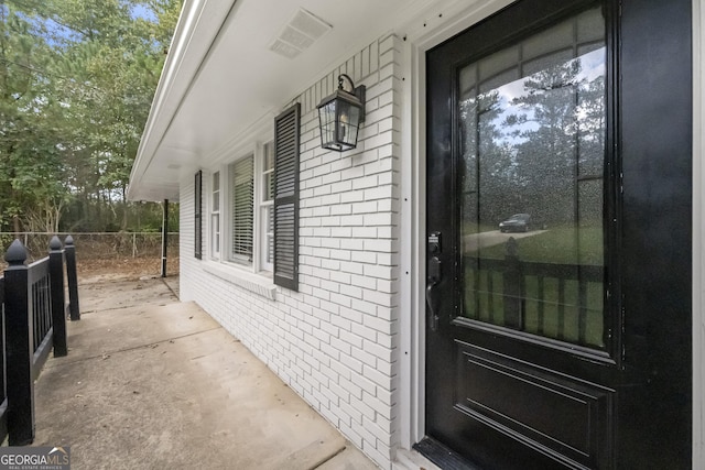 view of exterior entry with covered porch