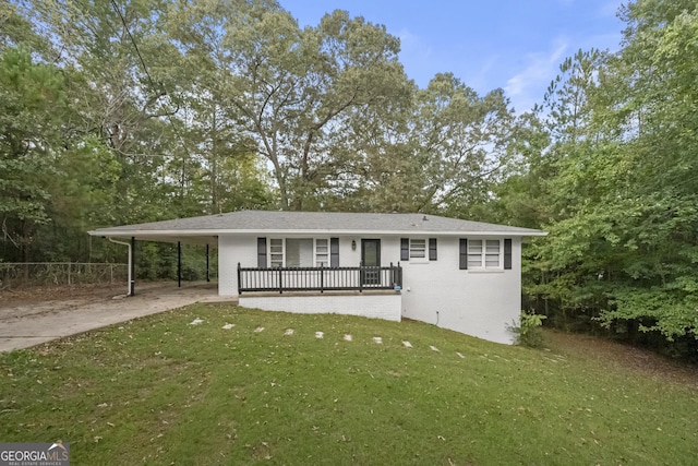 view of front of property with a carport and a front yard