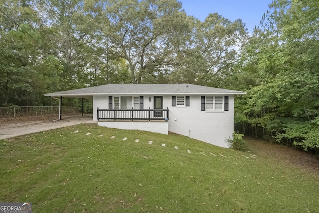 rear view of property featuring a carport and a yard