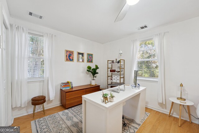 office area with light wood-type flooring and ceiling fan