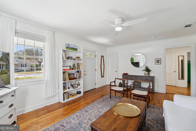 living room with ceiling fan and light hardwood / wood-style floors