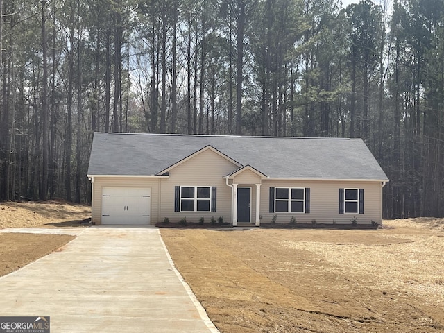 ranch-style house with a garage and driveway