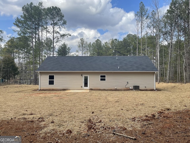 back of house with central AC unit