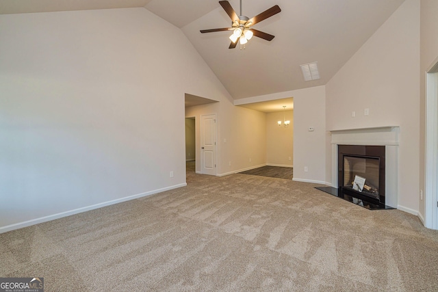 unfurnished living room with carpet, a glass covered fireplace, baseboards, and ceiling fan with notable chandelier