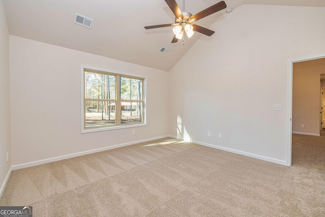 carpeted empty room featuring high vaulted ceiling, visible vents, ceiling fan, and baseboards