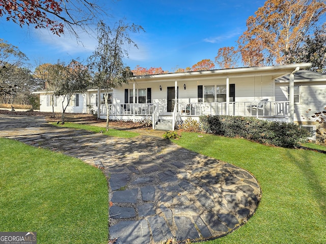 ranch-style house with covered porch and a front yard