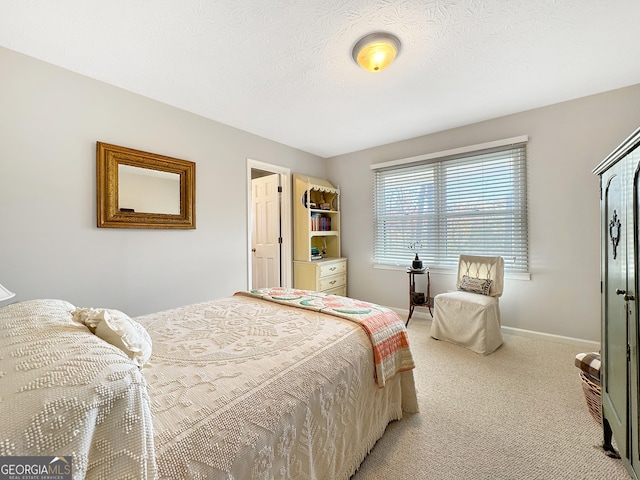 bedroom with a textured ceiling and light colored carpet