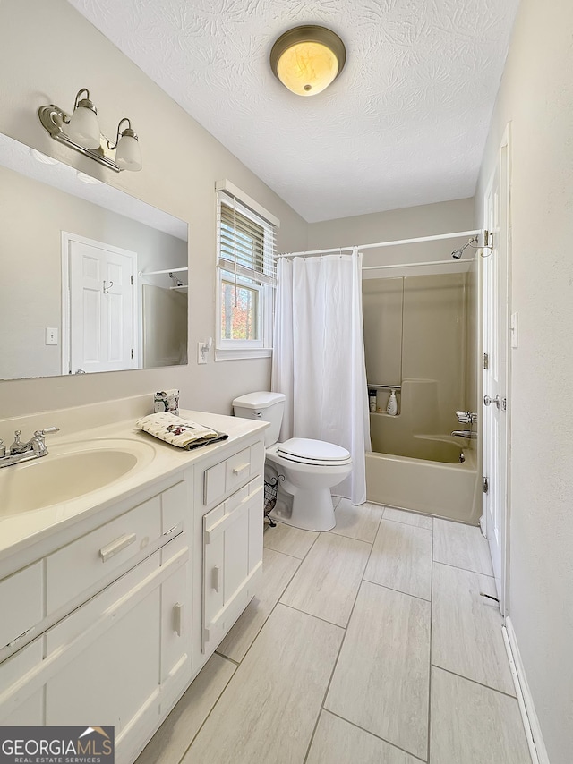 full bathroom featuring toilet, a textured ceiling, shower / bath combo with shower curtain, and vanity