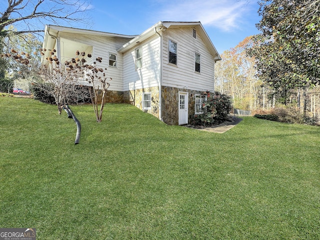 view of home's exterior with a lawn