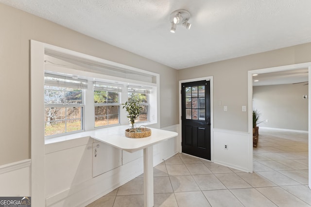 tiled entrance foyer with a textured ceiling