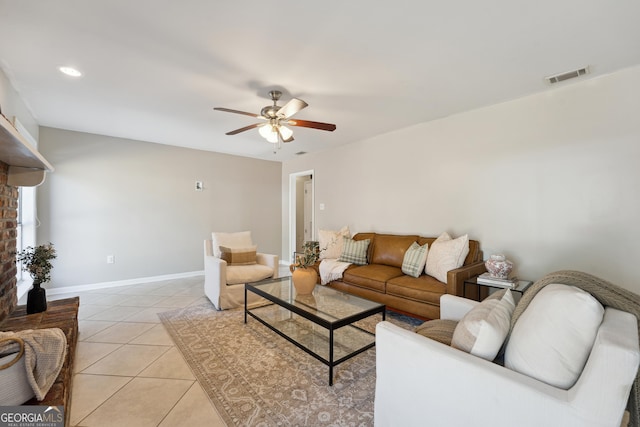 living room with light tile patterned floors, baseboards, visible vents, and ceiling fan