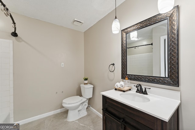 bathroom featuring vanity, tile patterned floors, a textured ceiling, and toilet