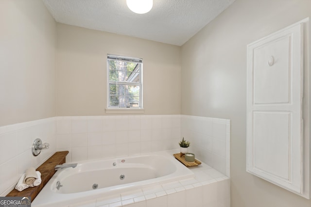 bathroom featuring a textured ceiling and a whirlpool tub