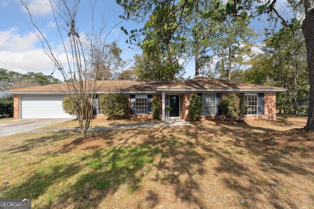 single story home featuring a front lawn, brick siding, concrete driveway, and an attached garage