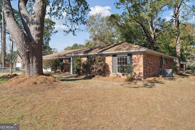 ranch-style house with central air condition unit and brick siding