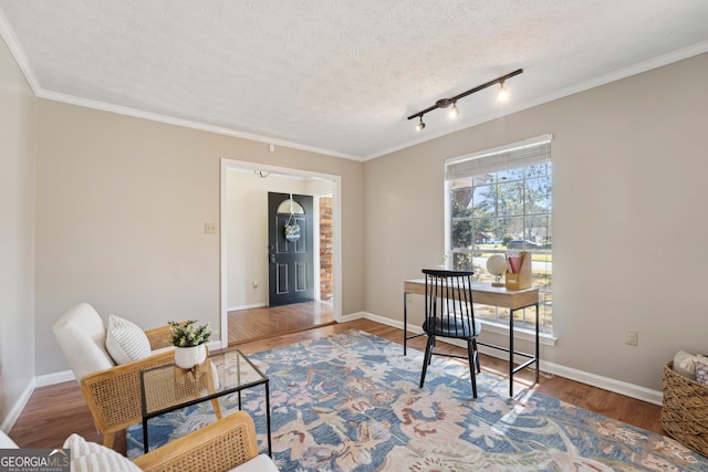 office space with a textured ceiling, baseboards, and wood finished floors