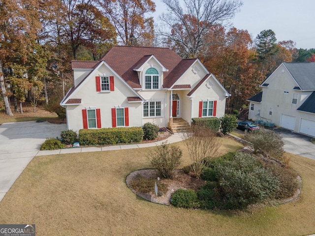 view of property featuring a front lawn