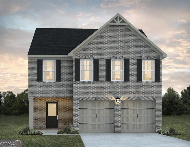 view of front of property featuring a lawn and a garage