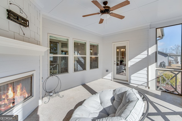 sunroom featuring ceiling fan