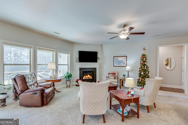 living room featuring ceiling fan and light colored carpet