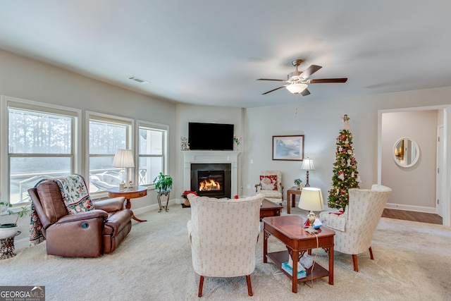 4336 Rockrose Green Way, Gainesville, GA 30504 - living area featuring light carpet, a glass covered fireplace, and ceiling fan
