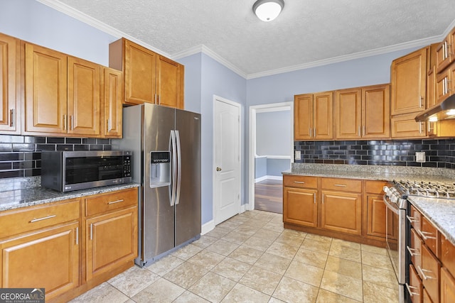 kitchen with crown molding, backsplash, stainless steel appliances, light stone counters, and a textured ceiling