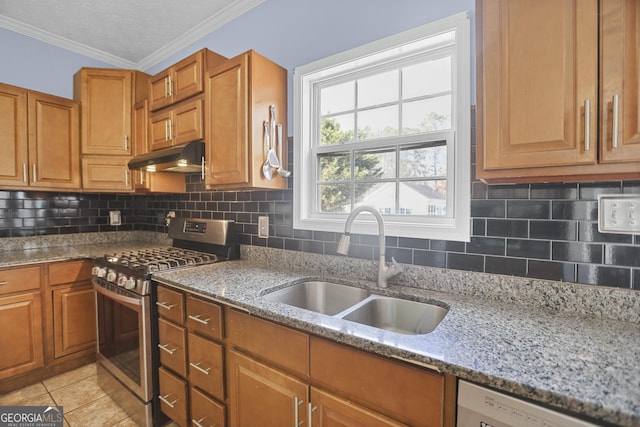 kitchen with gas range, sink, backsplash, and light stone counters