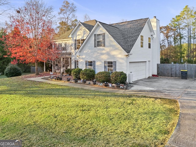 view of front of home featuring a garage and a front yard