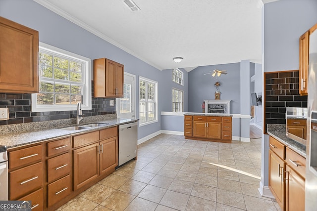 kitchen with dishwasher, sink, light tile patterned floors, and backsplash