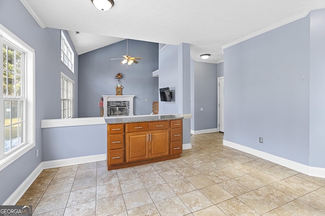 kitchen with a fireplace, lofted ceiling, light tile patterned floors, ceiling fan, and crown molding