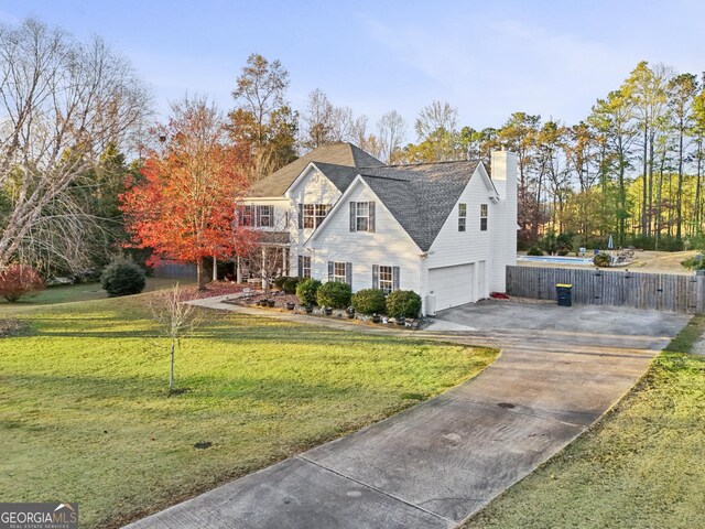 view of front of property featuring a garage and a front yard