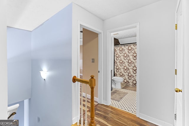 interior space featuring hardwood / wood-style flooring and a textured ceiling