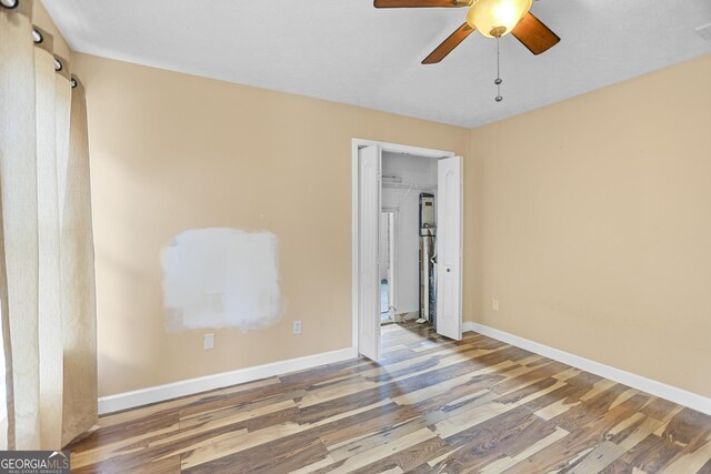 unfurnished bedroom with hardwood / wood-style flooring and ceiling fan